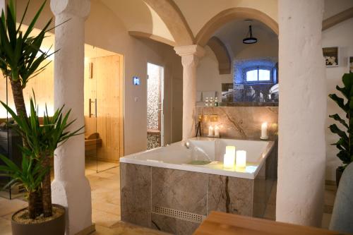 a bath tub in a room with columns at Privat SPA Premium Suite 117 qm in Wehlenberg