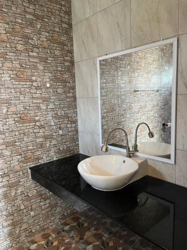 a bathroom with a white sink and a mirror at baan wongsupar in Suan Phung