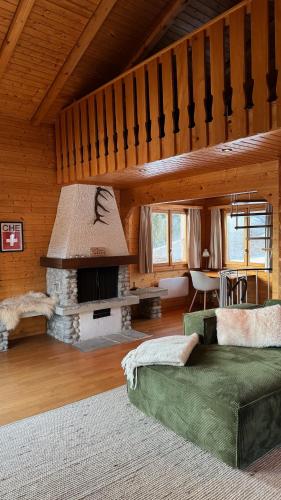a living room with a fireplace and a couch at Chalet Montis in Bellwald