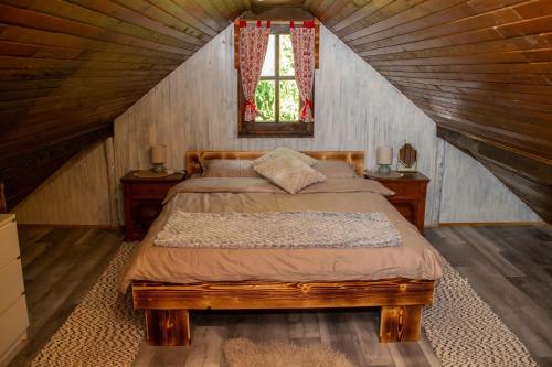 a bedroom with a bed in a attic at Wine Hill House Trsek with Jacuzzi in Vinagora