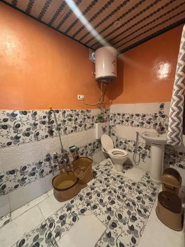a bathroom with a toilet and a sink at Karnai Residency in Srinagar