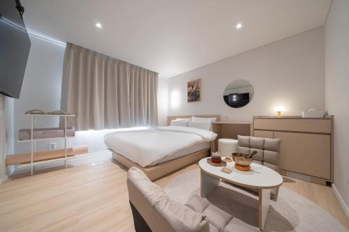 a hotel room with a bed and a couch at Anook Hotel Daejeon Daeheung in Daejeon