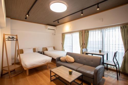 a living room with a couch and a bed at NIYS apartments 04 type in Tokyo