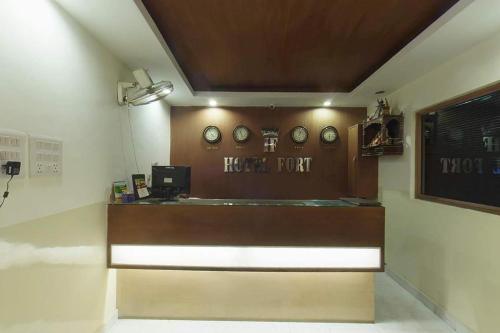 a ticket office with clocks on the wall at Hotel Fort in Patna
