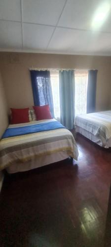 a bedroom with two beds and a window at Locsona flat in Margate