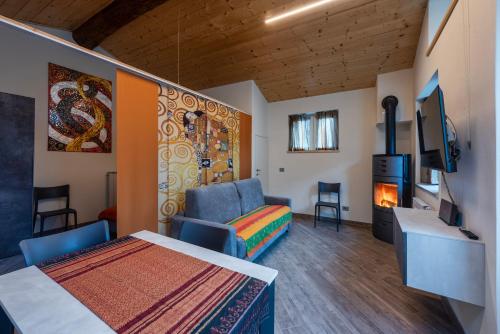 a room with a bed and a couch and a fireplace at L' Abbraccio in Caiolo