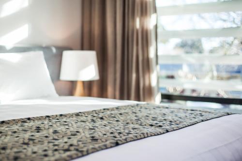 a hotel room with a bed and a window at One88 on Commerce in Whakatane