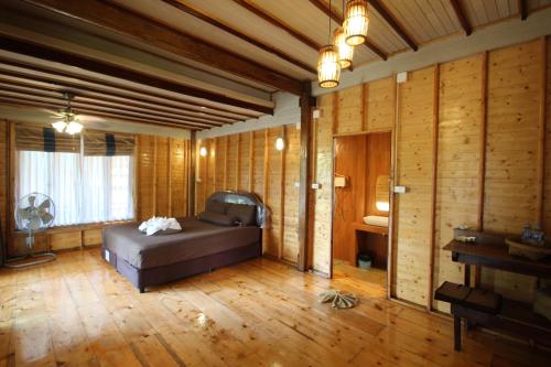 a bedroom with a bed in a room with wooden walls at Longbay Lipe in Ko Lipe