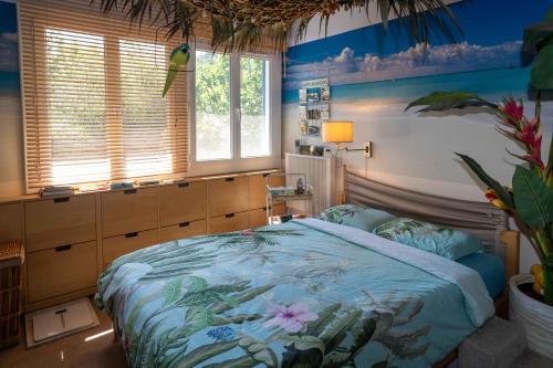 une chambre avec un grand lit et des murs bleus dans l'établissement Le Coco Loco, au Luc