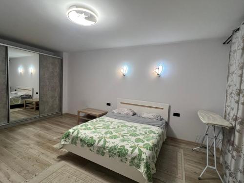 a bedroom with a bed and a mirror at Апартаменти біля АС-1 Зацепи in Lutsk