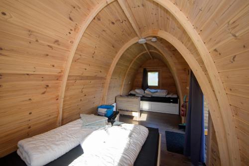 a room with a bed in a wooden room at Campland in Arcen