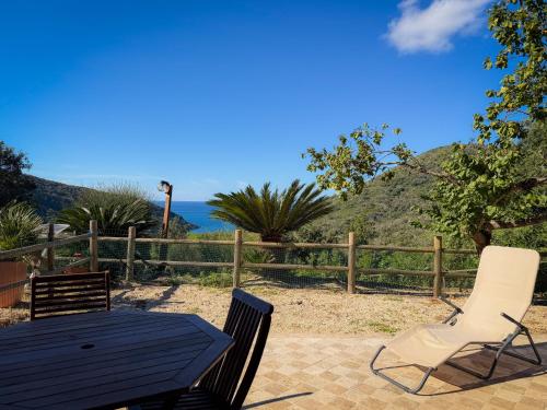 a table and two chairs on a patio at Casa Alessia , il tuo angolo di pace a Nisporto in Nisporto