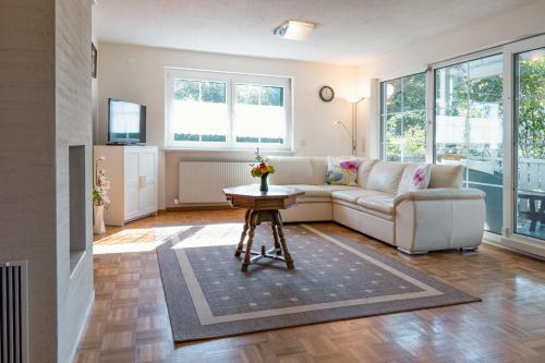 a living room with a couch and a table at Gardenia-Altach, 2-4 P, Küche, Garten, Terrasse, Parkplatz, Wifi, Ski Stellplatz in Altach