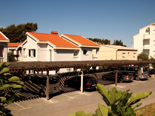 a group of cars parked in a parking lot at Villas Rab Banjol in Rab