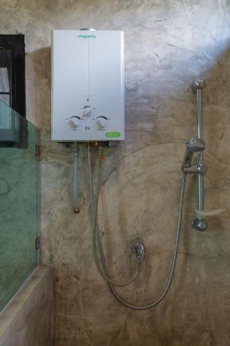 a shower in a bathroom with a sink at Phu Pha View Doi in Samoeng