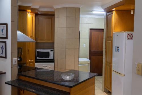a kitchen with a counter top and a refrigerator at The Shores, Ramsgate in Ramsgate