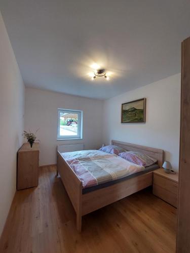 a bedroom with a large bed in a room at Ferienhaus Skarbina in Zell-Pfarre