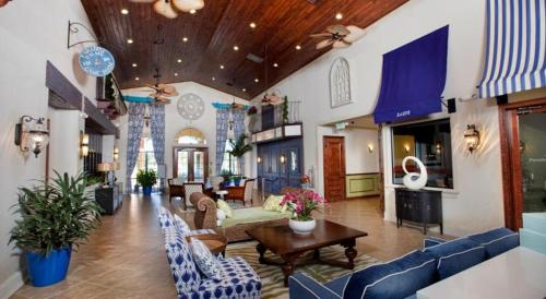 a large living room with blue couches and a table at Family 4-Bedroom Pool Home Near Disney World in Kissimmee