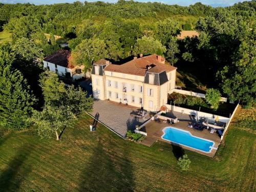 an aerial view of a large house with a swimming pool at Chateau de la Coutere in Saint-Laurent