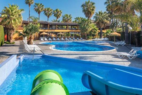 a swimming pool with a slide in a resort at Camping Enmar - Mobil home 3 pièces 4 personnes climatisé + TV MAE-5300 in Pineda de Mar
