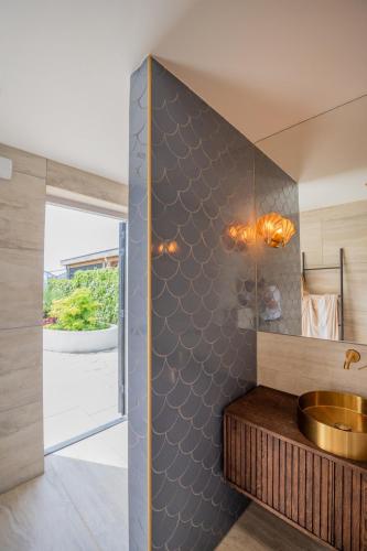 a bathroom with a sink and a mirror at 8 persons Wellness Villa Tulpenacker in Roelofarendsveen