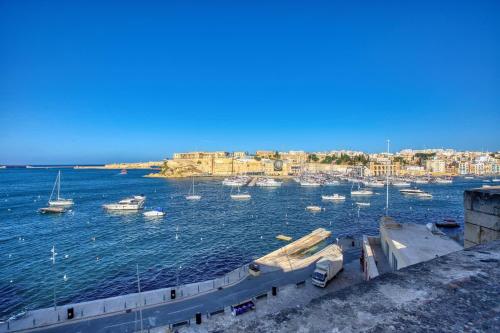 a view of a harbor with boats in the water at Studio in Historic Birgu in Birgu