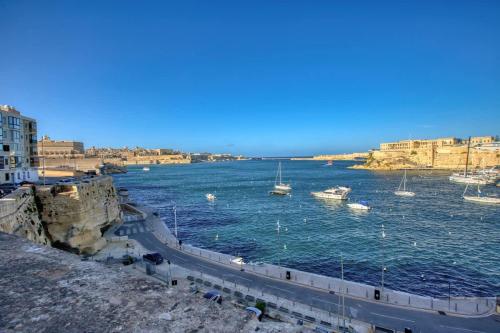 a view of a river with boats in the water at Studio in Historic Birgu in Birgu
