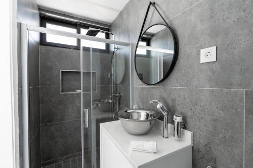 a bathroom with a sink and a mirror at Golf View Apartments in Maputo