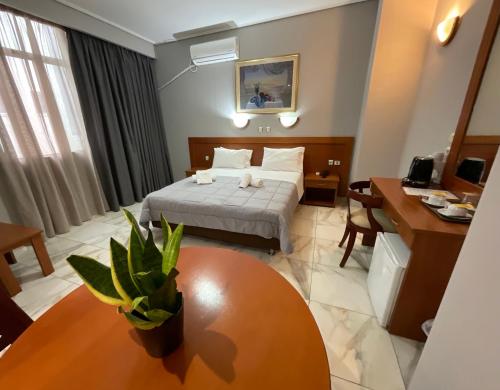 a hotel room with a bed and a table at Piraeus Acropole Hotel in Piraeus