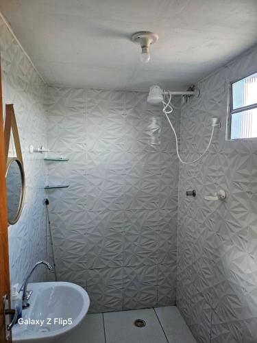 a bathroom with a shower and a sink at Pousada Tereza in Piranhas