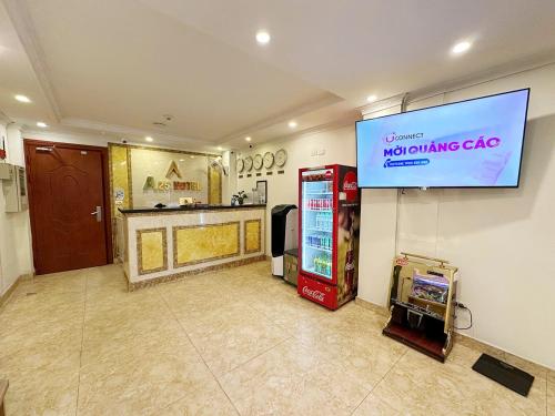a room with a video game machine and a sign on the wall at A25 Hotel - 109 Trúc Bạch in Hanoi