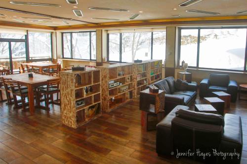 a living room with a couch and a table and chairs at Morino Lodge - Myoko in Myoko