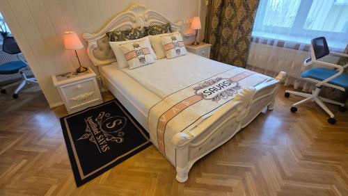 a bedroom with a large bed with a white bed frame at ApartHotel SAVAS 2 Apartments in Kaunas and parking in Kaunas