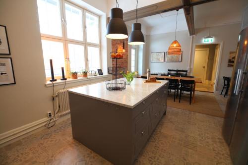 a kitchen with a large island in the middle of a room at Stationshuset bed and breakfast i Ed in Ed