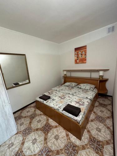 a bedroom with a bed and a mirror on the wall at Бордуляка 11 in Ternopil