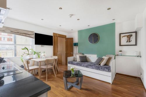 a living room with a couch and a table at Berkeley Street Residences in London
