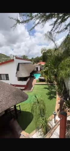 a view of a yard with a swimming pool at Tourmaline GuestHouse in Windhoek