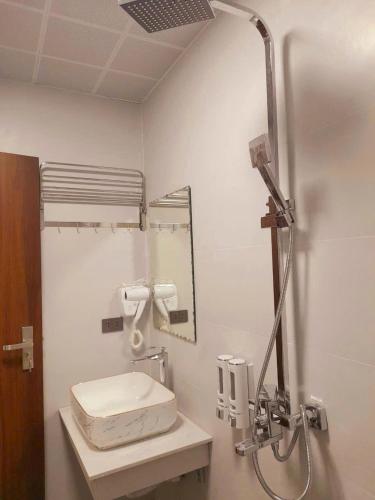 a bathroom with a sink and a mirror at OnMe in Sapa