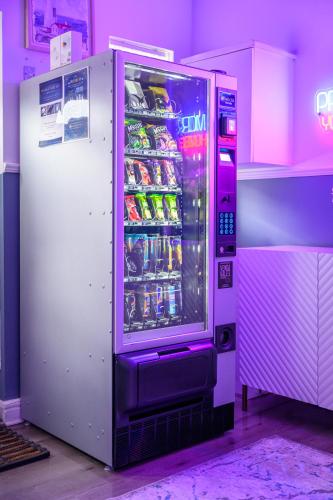 a vending machine with soda and drinks in it at Prestige Rooms MCR - Close to City Centre-Etihad Stadium - Fast WIFI in Manchester