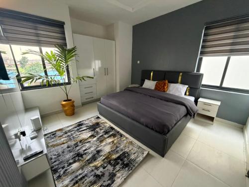 a bedroom with a large bed and a rug at Max Heights in Ikeja