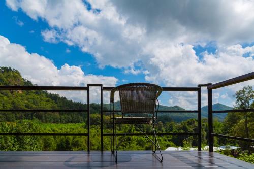 a chair sitting on a deck with a view at Phu Pha View Doi in Samoeng