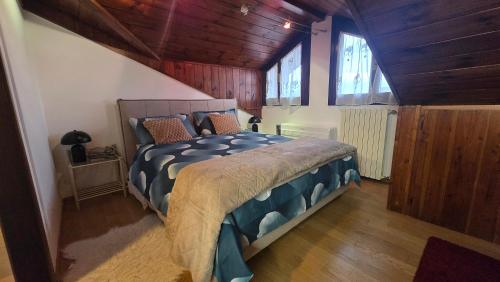a bedroom with a bed with a wooden ceiling at Oleggio Home in Oleggio