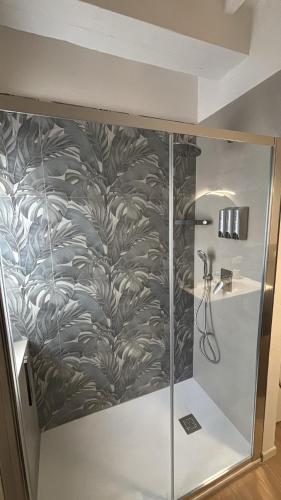 a bathroom with a shower with a wall at La terrazza del Papa in Pienza