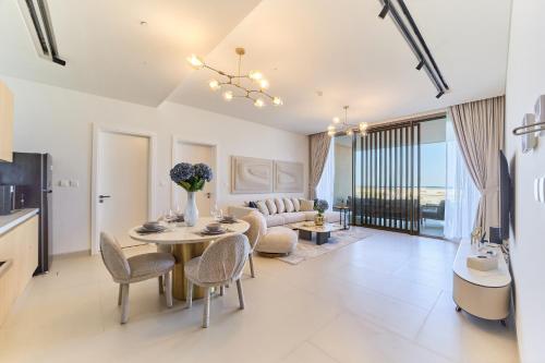 a living room with a table and a couch at Seaside Hills Al Zorah By fam Living in Ajman
