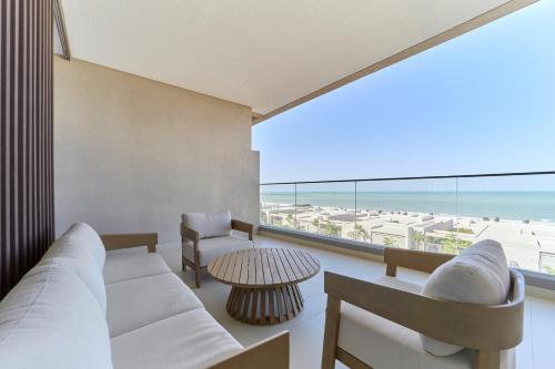 a living room with a couch and a table at Seaside Hills Al Zorah By fam Living in Ajman