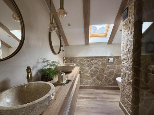 a bathroom with a large tub and a sink at Atico de lujo en el Pirineo in El Pueyo de Jaca