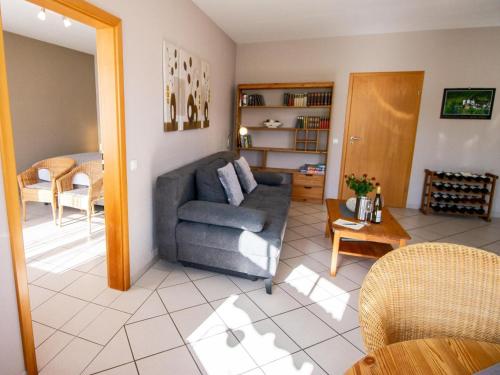 a living room with a couch and a table at Romantischer Aufenthalt mit Blick auf den Weinberg in Kinheim
