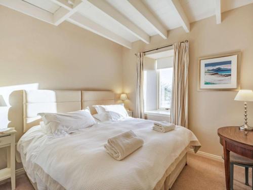 a bedroom with a large white bed with two towels on it at 4 Bed in Mindrum oc-86272 in Carham