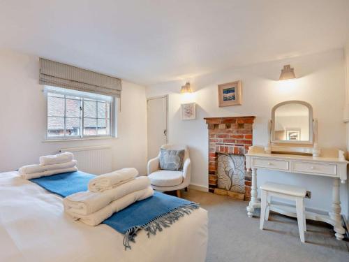 a bedroom with two beds and a fireplace at 3 Bed in Brockenhurst oc-nfl82 in Beaulieu