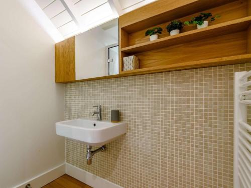 a bathroom with a sink and a tiled wall at 2 Bed in Scarborough oc-82543 in Snainton